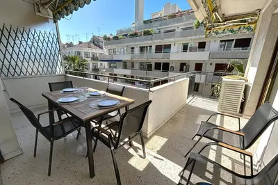 a table and chairs on a balcony with a view of a building at Wide and sunny 3 BR 2 Baths heart of Cannes gorgeous terrace city ctr in Cannes