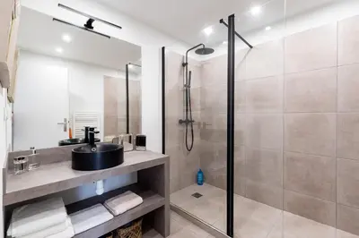 a bathroom with a sink and a shower at Geoffrey By Terrys Homes in Cannes