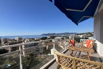 a balcony with chairs and a view of the ocean at Geoffrey By Terrys Homes in Cannes