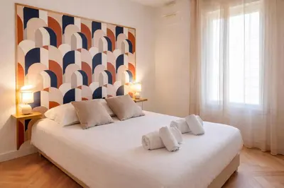 a bedroom with a large white bed with two pillows at Apt Lumineux avec Terrasse à 5' du Centre in Cannes