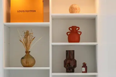a book shelf with vases and bottles on it at Apt Lumineux avec Terrasse à 5' du Centre in Cannes