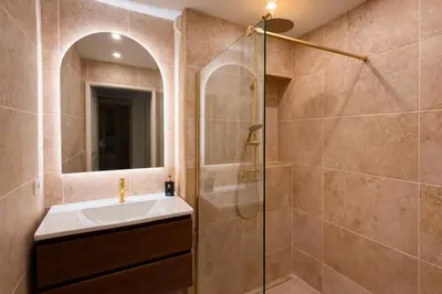 a bathroom with a sink and a shower at Apt Lumineux avec Terrasse à 5' du Centre in Cannes