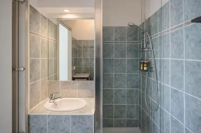 a bathroom with a sink and a shower at Apt Lumineux avec Terrasse à 5' du Centre in Cannes