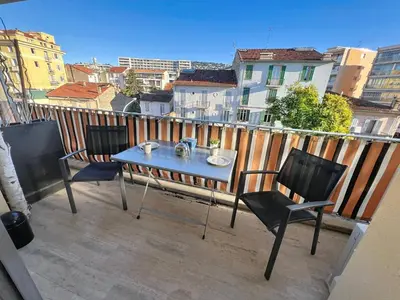 a table and two chairs on a balcony at Bright and vast studio terrace easy parking Cannes heart of town 1 mn in Cannes