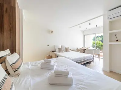 a white bedroom with two beds and a dining room at Elegant apartment - AC-4P - Cannes in Cannes
