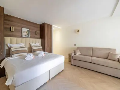 a bedroom with a large bed and a couch at Elegant apartment - AC-4P - Cannes in Cannes