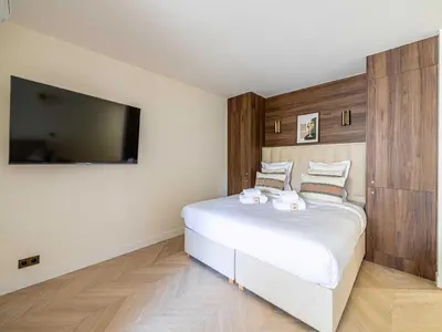 a bedroom with a large bed and a flat screen tv at Elegant apartment - AC-4P - Cannes in Cannes