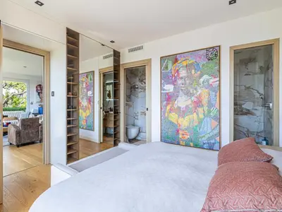 a bedroom with a large painting on the wall at Modern flat with sea view - AC- 2BR- 4P - Cannes in Cannes