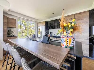 a kitchen with a large wooden table and chairs at Modern flat with sea view - AC- 2BR- 4P - Cannes in Cannes