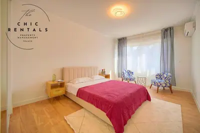 a hotel room with a bed and two chairs at ISABELLE New spacious 3BR Apt AC in Cannes
