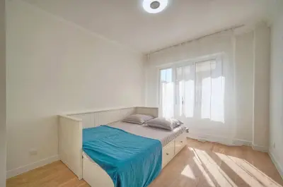 a white bedroom with a bed and a window at ISABELLE New spacious 3BR Apt AC in Cannes