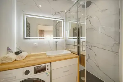 a bathroom with a washing machine and a shower at ISABELLE New spacious 3BR Apt AC in Cannes