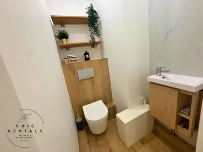 a small bathroom with a toilet and a sink at ISABELLE New spacious 3BR Apt AC in Cannes