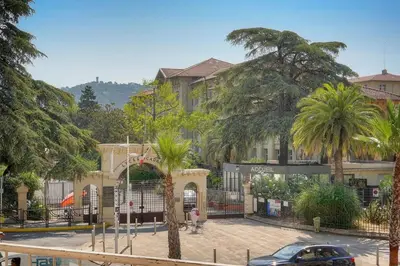 a building with palm trees in front of a street at ISABELLE New spacious 3BR Apt AC in Cannes