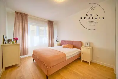 a bedroom with a bed and a sign that reads ch rite rentals at ISABELLE New spacious 3BR Apt AC in Cannes
