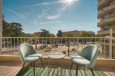 two chairs and a table on a balcony at ISABELLE New spacious 3BR Apt AC in Cannes
