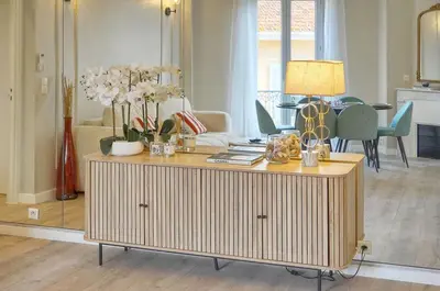 a living room with a table with flowers on it at Emily 2 bedrooms 2 baths near Palais in Cannes