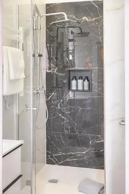 a shower with a glass door in a bathroom at Emily 2 bedrooms 2 baths near Palais in Cannes