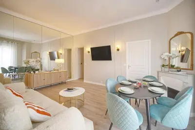a living room with a couch and a table and chairs at Emily 2 bedrooms 2 baths near Palais in Cannes
