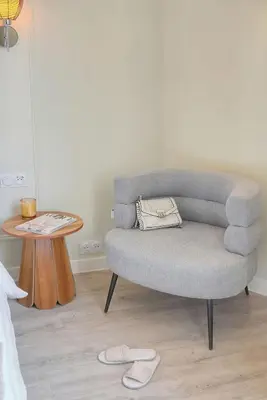 a living room with a gray chair and a table at Emily 2 bedrooms 2 baths near Palais in Cannes