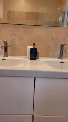 a bathroom sink with a soap dispenser on it at Spacieux et lumineux 2 chambres terrasse in Le Cannet