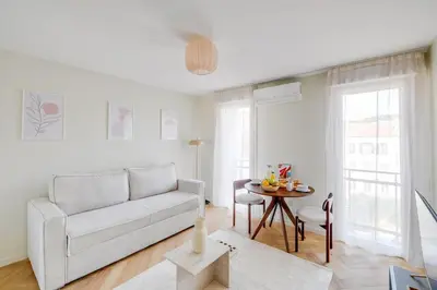 a living room with a couch and a table at Cozy Cannes in Cannes
