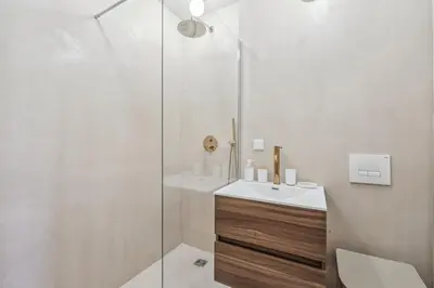 a white bathroom with a sink and a shower at Cozy Cannes in Cannes