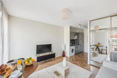 a white living room with a table and a couch at Cozy Cannes in Cannes
