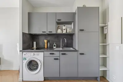 a kitchen with a washing machine and a sink at Cozy Cannes in Cannes