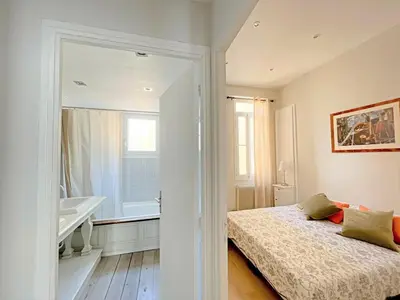 a bedroom with a bed and a bathroom with a tub at IRIS APARTMENT backCroisette in Cannes