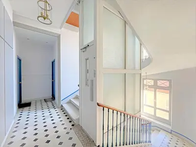 a hallway with a staircase and a window at IRIS APARTMENT backCroisette in Cannes