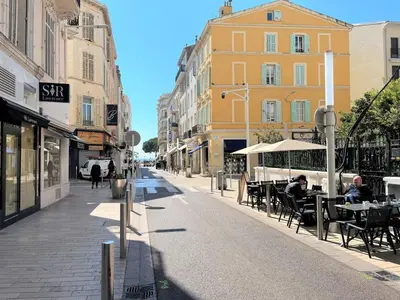 an empty city street with tables and chairs and buildings at IRIS APARTMENT backCroisette in Cannes