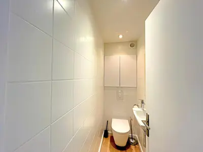 a white bathroom with a toilet and a sink at IRIS APARTMENT backCroisette in Cannes