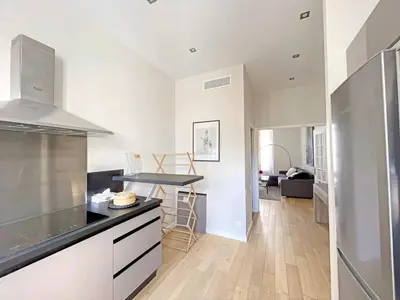 a kitchen with white cabinets and a counter top at IRIS APARTMENT backCroisette in Cannes
