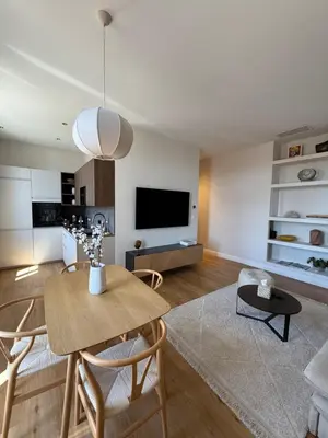 a living room with a table and a tv at Maison Dalaise - Cannes in Cannes
