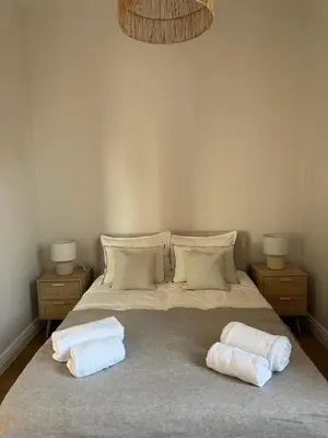 a bedroom with a bed with two towels on it at Maison Dalaise - Cannes in Cannes