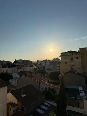 a sunset over the roofs of buildings in a city at Maison Dalaise - Cannes in Cannes