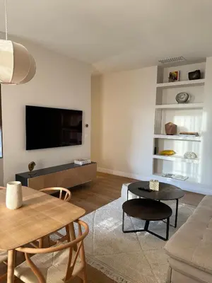 a living room with a flat screen tv on a wall at Maison Dalaise - Cannes in Cannes