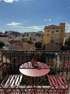 a table with a surfboard on top of a balcony at Maison Dalaise - Cannes in Cannes