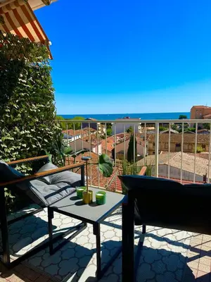 a balcony with a table and a view of the ocean at Shiny Sea View Flat vue merTerrace in Cannes in Cannes