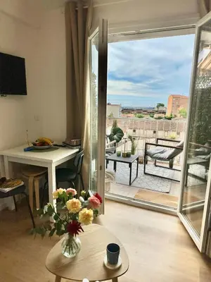 a living room with a door open to a patio with a view at Shiny Sea View Flat vue merTerrace in Cannes in Cannes