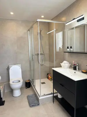 a bathroom with a shower and a toilet and a sink at Shiny Sea View Flat vue merTerrace in Cannes in Cannes