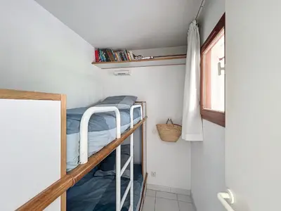 a small room with bunk beds and a window at Appartement Cannes vue sur mer in Cannes