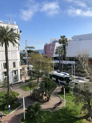 a bus is parked in a street in a city at Merimee 3D in Cannes