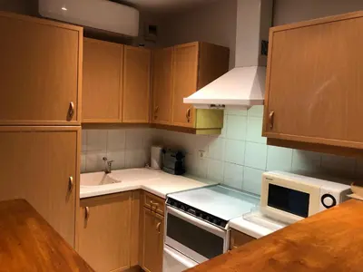 a small kitchen with a table with a vase on it at Merimee 3D in Cannes