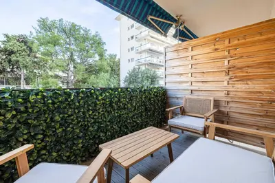 a patio with two benches and a fence at Renovated apt with Parking & Terrace - Palm Beach in Cannes