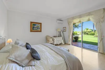 a bedroom with a bed and a view of a yard at REF 1849 - Cannes - Villa Provencal Style to rent in Le Cannet