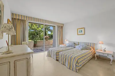 a bedroom with a bed and a desk and a window at REF 1849 - Cannes - Villa Provencal Style to rent in Le Cannet