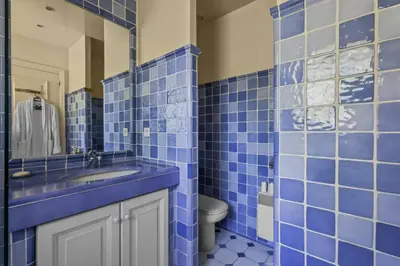 a blue tiled bathroom with a sink and a toilet at REF 1849 - Cannes - Villa Provencal Style to rent in Le Cannet