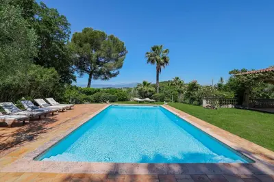 a swimming pool in a backyard with chairs and trees at REF 1849 - Cannes - Villa Provencal Style to rent in Le Cannet